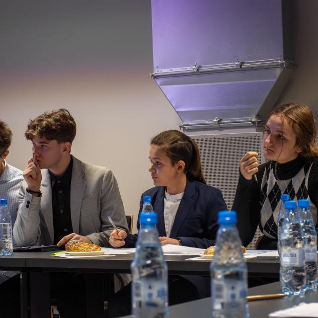 skupieni uczestnicy debaty przy stole